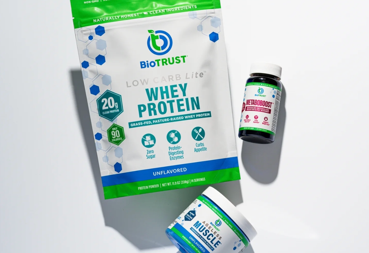 Biotrust whey protein package with a bottle on a light gray background